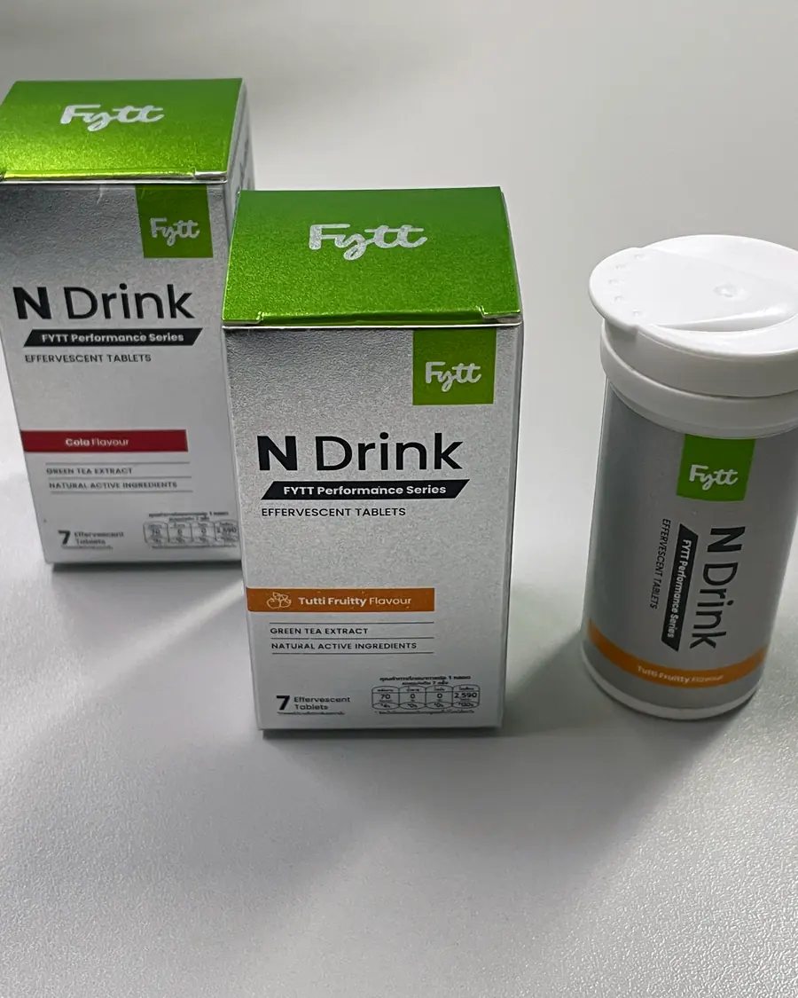 Two FYTT N Drink effervescent tablet boxes, silver with a green lid, beside a matching tablet tube.