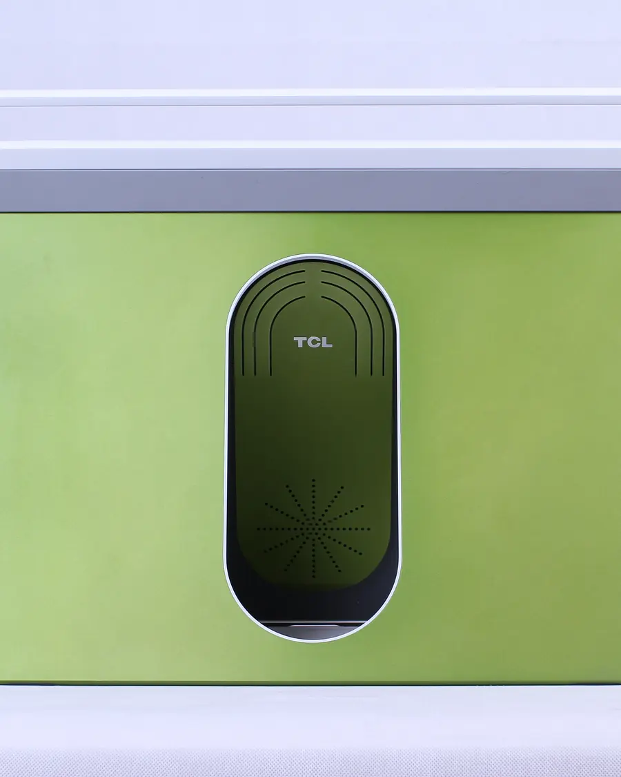 The JIM mock-up from behind: a green panel with a white carry handle and an oval TCL badge.