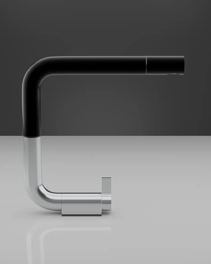 The Küche kitchen tap: a black spout on a brushed steel body, against a charcoal wall.