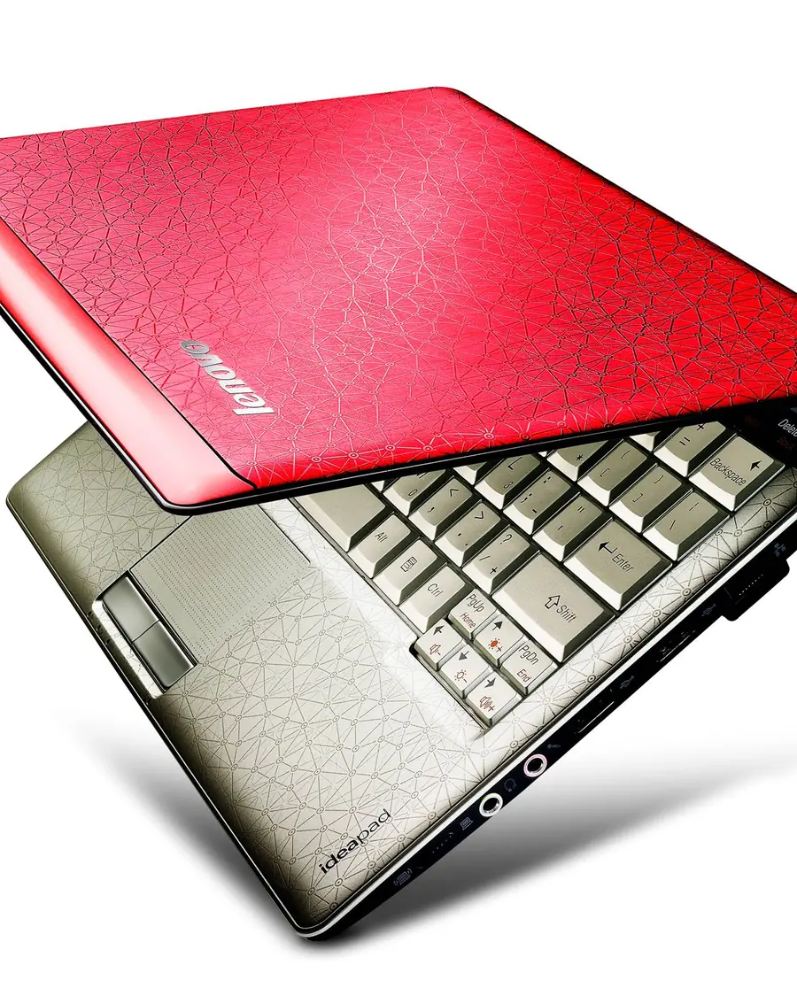 A Lenovo IdeaPad U150 half open, with a red patterned lid and a champagne keyboard deck.